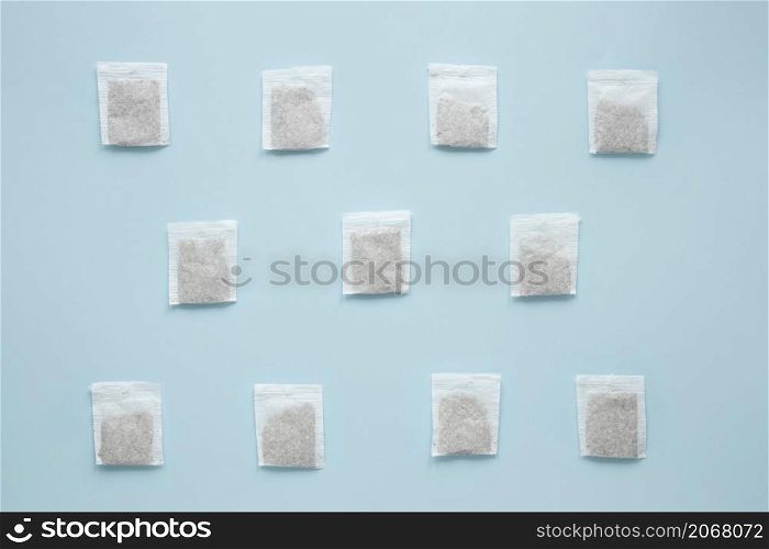 overhead view teabags arranged against blue background