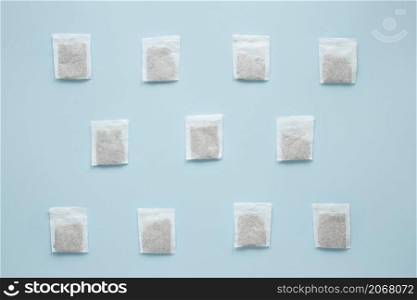 overhead view teabags arranged against blue background