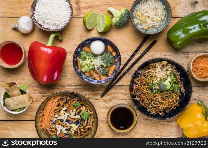 overhead view traditional thai food with sauces wooden plank