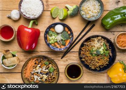 overhead view traditional thai food with sauces wooden plank
