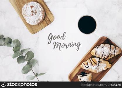 overhead view twig coffee bun croissants with good morning message marble texture backdrop