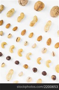overhead view walnuts peanuts almonds pistachios hazelnut cashew nuts white background