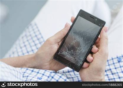 overhead view woman holding broken mobile display screen. Resolution and high quality beautiful photo. overhead view woman holding broken mobile display screen. High quality and resolution beautiful photo concept