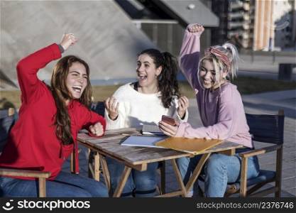 Overjoyed female students celebrating successful final tests