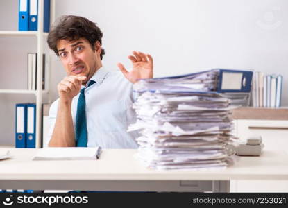 Overloaded busy employee with too much work and paperwork