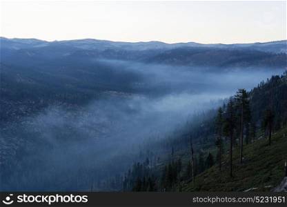 Overlooking a smokey mountain valley at sunrise
