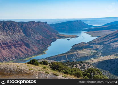 Overlooking Green River from the Flaming Gorge Green River Scenic Byway in Utah showing red-colored mountains and high desert plant life