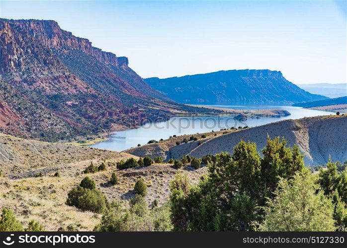 Overlooking Green River from the Flaming Gorge Green River Scenic Byway in Utah showing red-colored mountains and high desert plant life