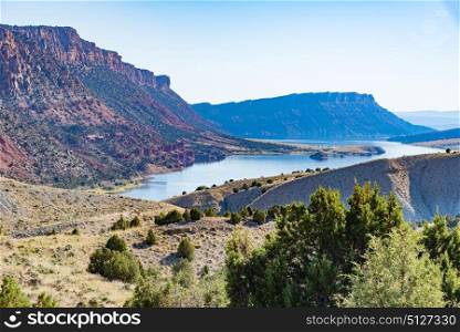 Overlooking Green River from the Flaming Gorge Green River Scenic Byway in Utah showing red-colored mountains and high desert plant life