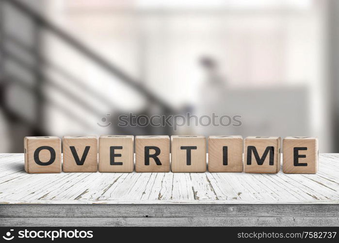 Overtime word spelled with wooden blocks in an office environment