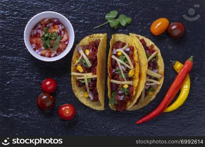 overview of three tacos on slate