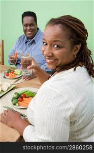 Overweight mid-adult couple having healthy meal