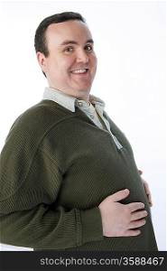 Overweight mid-adult man with hands on his belly