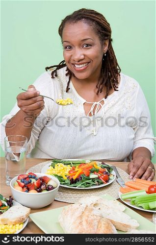 Overweight mid-adult woman having healthy meal