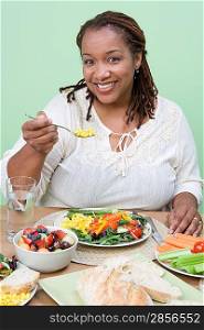 Overweight mid-adult woman having healthy meal