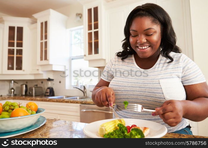 Overweight Woman Eating Healthy Meal in Kitchen