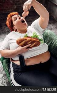 Overweight woman eats sandwich, bulimic, obesity problem. Unhealthy lifestyle, fat female. Overweight woman eats sandwich, bulimic, obesity