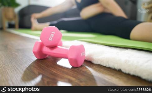 Overweight woman exercising for weight loss. exercise with dumbbells in stretching positions at home in the living room CheerfulFat woman diet healthy lifestyle concept