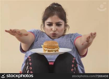 Overweight Woman Exercising with Burger