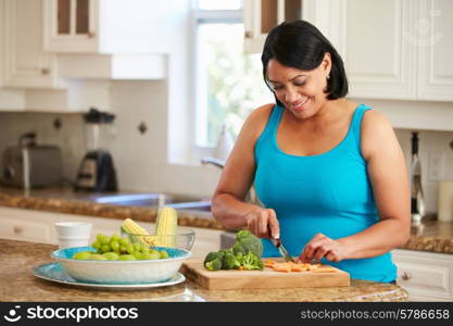 Overweight Woman Preparing Vegetables In Kitchen