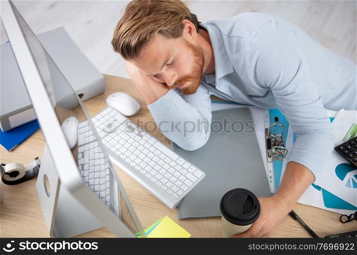 overworked businessman sleeping at table