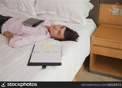 Overworked businessman sleeping in his bed