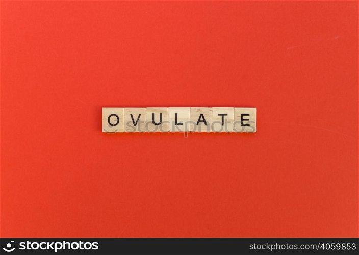 ovulate word with scrabble letters red background