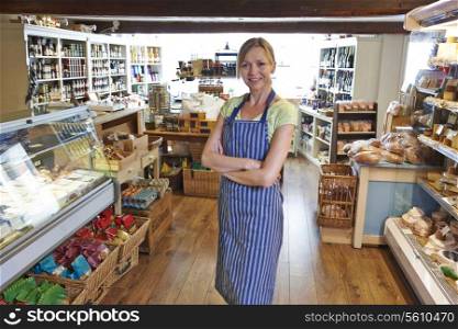 Owner Of Delicatessen Standing In Shop