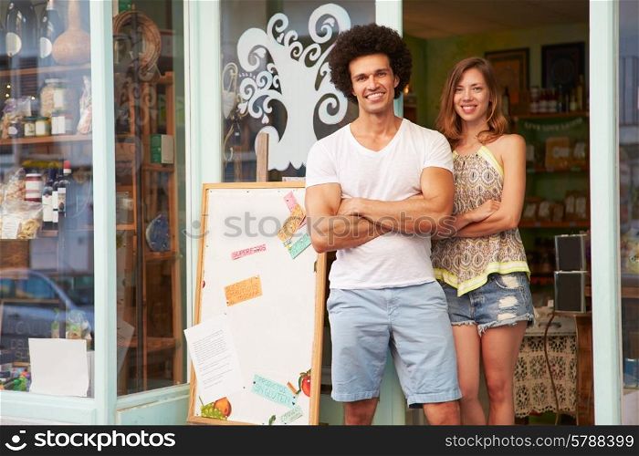 Owners Of Delicatessen Standing Outside Shop Together
