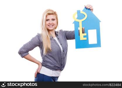 Ownership and property concept. Happy woman holding blue paper house and big keys, moving to new home.. Happy woman holding blue paper house