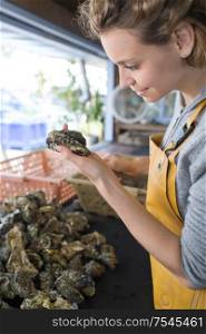 oyster female farmer cleans what she has produced
