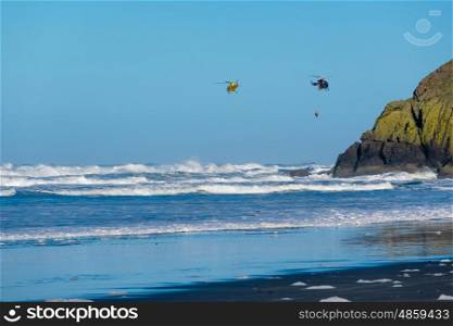 Pacific coast, Cape Disappointment, WA, USA. Coast guard helicopters in the sky.