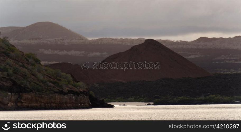 Pacific Ocean with mountain range in the background, Santiago Island, Galapagos Islands, Ecuador