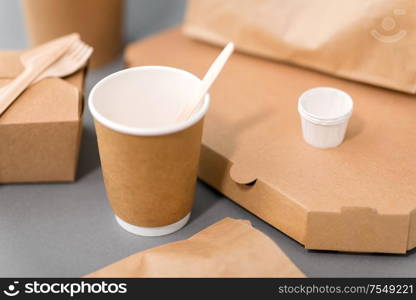 package, recycling and eating concept - disposable paper containers for takeaway food on table. disposable paper containers for takeaway food