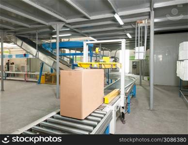 packed electrical engineering cardboard boxes on a conveyor belt in factory. plant for the production of household air conditioners