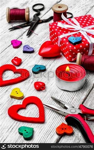 Packing holiday gifts for Valentine day.Thread,button and symbolic heart.