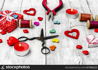 Packing holiday gifts for Valentine's day.Thread,button and symbolic heart.