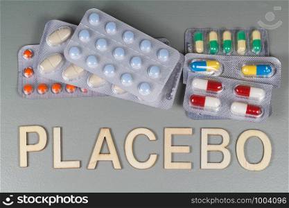 Packs of pills and placebo written in wooden letters