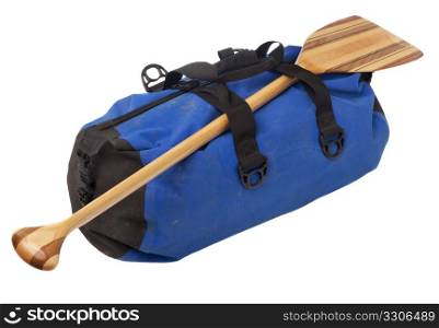paddling trip or vacation concept - wooden canoe paddle and waterpoof duffel with river mud stains, isolated on white