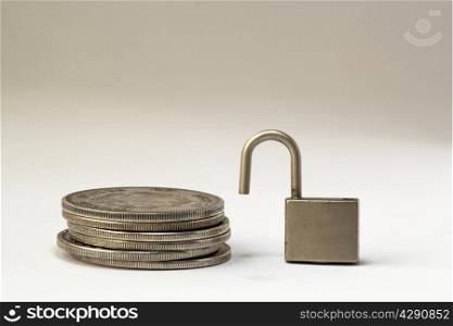padlock and coins on the white background