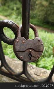 padlock on the railing bridge for the happiness of newlyweds. open-hole barn lock