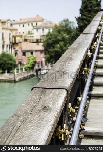 Padlocks of lovers placed on the bridge in Venice
