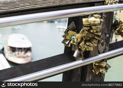 Padlocks of lovers placed on the bridge in Venice