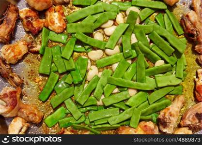 Paella from Spain recipe process ad vegetables green beans and garrofon