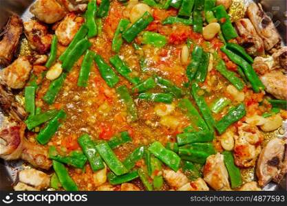 Paella from Spain recipe process ad vegetables green beans and tomato