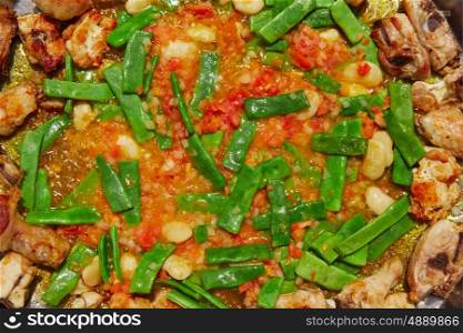 Paella from Spain recipe process ad vegetables green beans and tomato