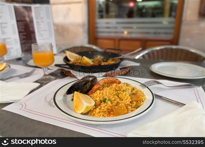 Paella on the plate in street cafe of Barcelona, Spain&#xA;