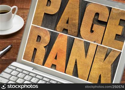 page rank - text in vintage letterpress wood type on a laptop screen - internet and SEO concept