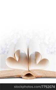 Pages of a book curved into a heart shape on white background, love reading Valentine day. Pages of a book curved into heart