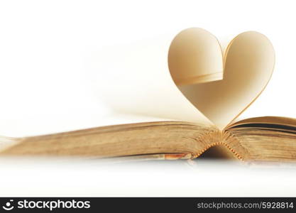 Pages of open book rolled in heart shape isolated on white